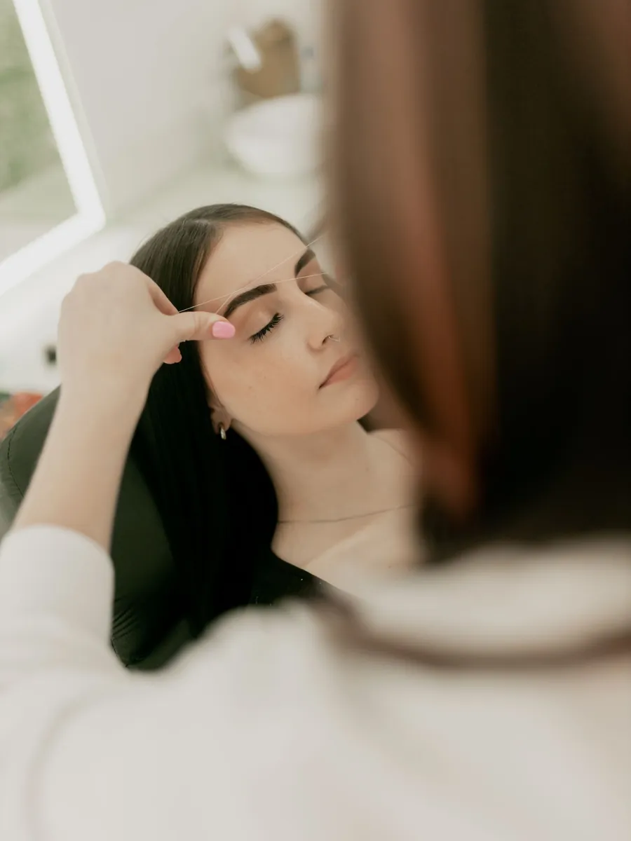 Eyebrow shaping in a bright studio