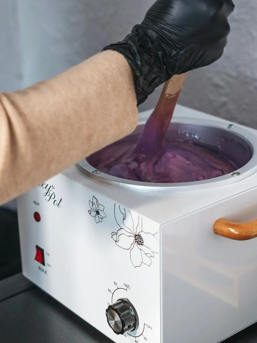 Esthetician preparing warm wax