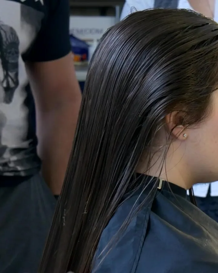 Stylist sectioning a woman's hair